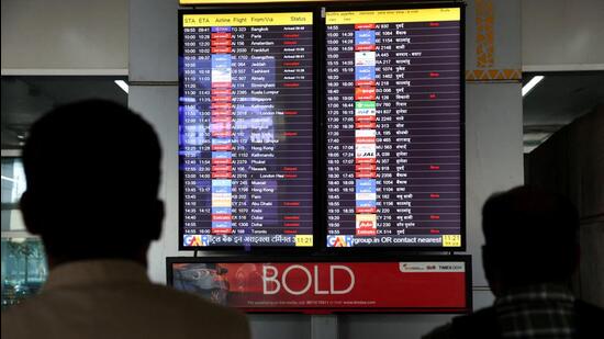 People look at a screen displaying flight information at IGI airport in Delhi. (Reuters File)
