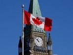 A Canadian flag flies in front of the Peace Tower on Parliament Hill in Ottawa, Ontario, (REUTERS)