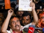BJP candidate for Bhabanipur and Nandigram constituencies, Suvendu Adhikari, shows a certificate of election after winning. (PTI)