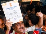 BJP candidate for Bhabanipur and Nandigram constituencies, Suvendu Adhikari, shows a certificate of election after winning in both the constituencies for the West Bengal Assembly elections results.