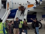 Passengers making their way to the Chandigarh airport terminal after the emergency evacuation via inflatable slides on Tuesday. (X)
