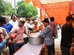 People distribute sugarcane juice at a bhandara on the occasion of Bada Mangal in Lucknow on Tuesday. (Mushtaq Ali/HT)