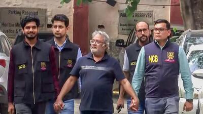New Delhi, Apr 28 (ANI): Narcotics Control Bureau (NCB) officials take custody of wanted drug trafficker Mohammed Salim Dola at IGI Airport, Dola was brought back from Turkey under 'Operation Global-Hunt' and is set to be presented before a local court later today, in New Delhi on Tuesday. (ANI Video Grab) (ANI Video Grab) New Delhi, Apr 28 (ANI): Narcotics Control Bureau (NCB) officials take custody of wanted drug trafficker Mohammed Salim Dola at IGI Airport, Dola was brought back from Turkey under 'Operation Global-Hunt' and is set to be presented before a local court later today, in New Delhi on Tuesday. (ANI Video Grab) (ANI Video Grab)