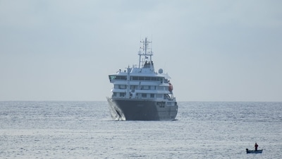 Hantavirus outbreak: On May 5, 2026, a fisherman sailed past the MV Hondius cruise ship anchored in the port of Praia, the capital of Cape Verde. (AFP photo) (AFP)