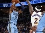 Memphis Grizzlies guard Ja Morant (12) shoots as Los Angeles Lakers forward Jarred Vanderbilt (2) defends