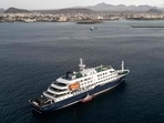 TOPSHOT - This aerial view shows health personnel boarding the cruise ship MV Hondius, while stationary off the port of Praia, the capital of Cape Verde, on May 6, 2026. 