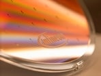 The Infineon logo on a wafer. The chip maker raised its sales and margin forecasts for the fiscal year.