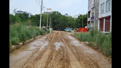 A cratered and waterlogged stretch of an internal road in Sector 47, in Gurugram, as seen on Tuesday. (Parveen Kumar/HT)
