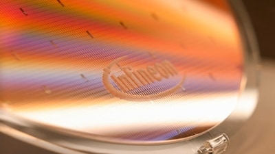 The Infineon logo on a wafer. The chip maker raised its sales and margin forecasts for the fiscal year.