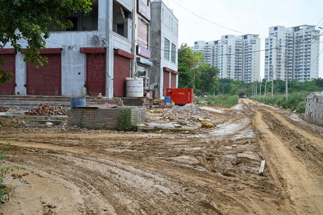 A cratered and waterlogged stretch of an internal road in Sector 47, in Gurugram, as seen on Tuesday. (Parveen Kumar/HT Photo)