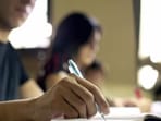 "Students doing homework and preparing exam at university, closeup of young man writing in college library" (Getty Images/iStockphoto)