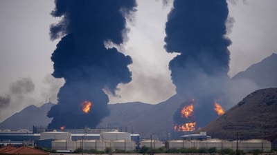 Plumes of smoke and fire rise after debris from an intercepted Iranian drone struck an oil facility, according to authorities, in Fujairah, United Arab Emirates, March 14. (AP)