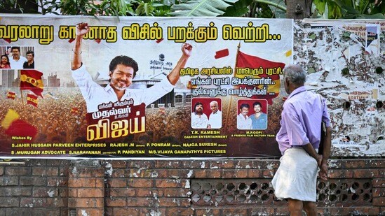 విజయ్ పోస్టర్ వైపు చూస్తున్న వ్యక్తి (AFP)