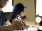 "Students doing homework and preparing exam at university, closeup of young man writing in college library" (Getty Images/iStockphoto)