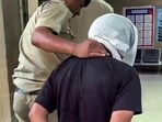 Accused Rahul Meena  being brought to Amar Colony Police Station, in New Delhi on Thursday. (ANI Video Grab)