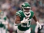 New York Jets running back Breece Hall (20) carries the ball during an NFL football game against the New England Patriots