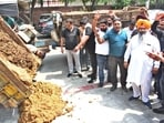 Dairy owners dumping cow dung outside the MC’s Zone D office during a protest in Ludhiana on Friday. (HT File)