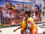 A woman walks past a banner of actor and Tamilaga Vettri Kazhagam (TVK) President Chandrasekaran Joseph Vijay, after his party surprisingly emerged as the single largest party in the April 23 polls to the Tamil Nadu state assembly, in Chennai on Thursday, May 7, 2026.