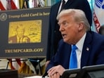 A poster showing the Trump Gold Card is seen as President Donald Trump signs executive orders in the Oval Office of the White House, Sept. 19, 2025, in Washington. 