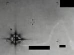 The video appears to show a glowing object with eight protruding points or arms drifting through the frame.