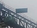 A viral clip from May 9 shows strong winds uprooting large tin sheets attached to an elevated metro structure, causing them to collapse onto the road below. (VIDEO GRAB)
