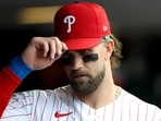 Bryce Harper #3 of the Philadelphia Phillies looks on in the dugout before a game against the Athletics Bryce Harper #3 of the Philadelphia Phillies looks on in the dugout before a game against the Athletics