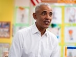 Former US President Barack Obama speaks with students during a visit to Learning Through Play Pre-K in New York