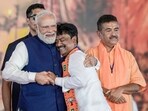 Prime Minister Narendra Modi being greeted by BJP MLA Ashok Kirtania as he takes the oath as a West Bengal cabinet minister during the swearing-in ceremony after party forms government in the state for the first time, at Brigade Parade Ground in Kolkata, West Bengal, Saturday, May 9, 2026. 