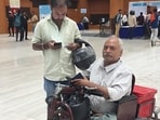 Ram Babu, a differently abled person comes to settle his traffic challan for not wearing helmet while driving at the National Lok Adalat at Gyan Bhawan in Patna on Saturday. (Santosh Kumar/HT)