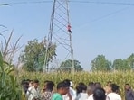 The man atop electricity tower in Bahraich. (HT PHOTO)