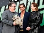 Director Jon Favreau, holding Grogu, alognside Pedro Pascal and Sigourney Weaver, posing for photographers upon arrival at the Star Wars: The Mandalorian and Grogu fan event in London.