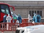 Passengers from the cruise ship MV Hondius affected by a hantavirus outbreak, board a bus at the port of Granadilla de Abona, in Tenerife, Spain, May 10, 2026. REUTERS/Hannah McKay