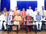 Governor Anandiben Patel, BJP state president Pankaj Chaudhry, UP CM Yogi Adityanath, Deputy CM Keshav Prasad Maurya and Deputy CM Brajesh Pathak pose for a group photo with the newly inducted ministers during the swearing-in ceremony of the Uttar Pradesh Cabinet expansion at Gandhi Sabhagar, Jan Bhawan, in Lucknow, Uttar Pradesh, India, on Sunday. (Deepak Gupta/HT)