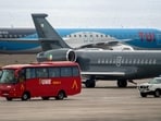 An Irish Air Corps plane (C) is pictured next to another plane, a Spain's Emergency Military Unit (UME) and a Spain's Guardia Civil vehicle at the Tenerife Sur-Reina Sofia airport on the island of Tenerife in Spain's Canary Islands on May 10, 2026. 