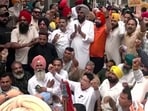 AAP supporters stage a protest holding placards outside the residence of BJP general secretary Tarun Chugh after ED action against AAP leaders.
