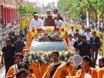 Prime Minister Narendra Modi waves to the crowd during a roadshow on the occasion of Somnath Amrut Mahotsav, celebrating 75 years of the inauguration of the restored Somnath temple, in Gir, Somnath, on Monday. Gujarat CM Bhupendra Patel and deputy CM Harsh Sanghavi are also present. 