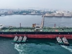 A cargo ship unloads imported crude oil at the Qingdao crude oil terminal in Chinas eastern Shandong province.