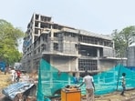 Green nets are set up at construction sites primarily to contain debris, reduce dust pollution, and protect workers and pedestrians from falling materials. (HT Archive)