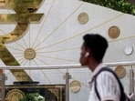 FILE PHOTO: FILE PHOTO: A man walks past an installation of the Rupee logo and Indian currency coins outside the Reserve Bank of India (RBI) headquarters in Mumbai, India, April 9, 2025. REUTERS/Francis Mascarenhas//File Photo/File Photo