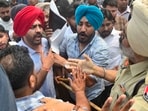 Protesters arguing with a police official during a protest near Gill Road on Sunday. (Gurpreet Singh/HT)