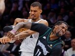 San Antonio Spurs center Victor Wembanyama (1) commits a level two flagrant foul against Minnesota Timberwolves center Naz Reid (11)