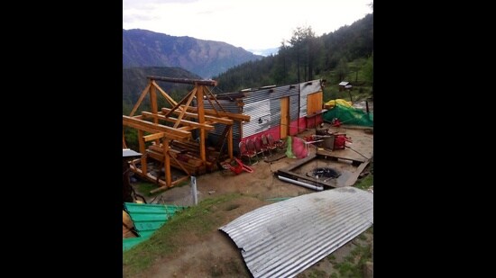 Blown roof of a house after strong winds in Kullu on Monday. (HT Photo)