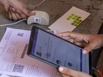 Officials verify documents of aspirants before they appear for the NEET-UG 2026 exam on May 3. (PTI)