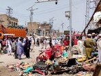 People and police officers in plain clothes gather after a blast at a market in Lakki Marwat, Khyber Pakhtunkhwa province, Pakistan, May 12, 2026. Picture taken with a mobile phone.