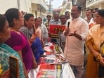 SP MP Utkarsh Verma with the protesting BJP Mahila Morcha workers outside his residence in Lakhimpur Kheri on Tuesday. (HT) SP MP Utkarsh Verma with the protesting BJP Mahila Morcha workers outside his residence in Lakhimpur Kheri on Tuesday. (HT)