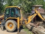 A demolition drive being carried out by Anantnag revenue department in coordination with Kulgam police against a drug peddler as part of the continued crackdown at Drinen Qazigund, in Anantnag on Tuesday. (PTI) A demolition drive being carried out by Anantnag revenue department in coordination with Kulgam police against a drug peddler as part of the continued crackdown at Drinen Qazigund, in Anantnag on Tuesday. (PTI)