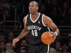 Former Brooklyn Nets center Jason Collins dribbles the ball during the second half of an NBA basketball game against the Los Angeles Lakers