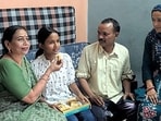 Rewari’s Deepika, celebrates with family members after securing the top position in Haryana in the Class 12 Board examinations. (Manoj Dhaka/HT)