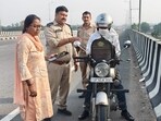 Transport department officials inspect motorcycles fitted with modified silencers during a special enforcement drive against pressure horns and noise pollution in Lucknow. (HT Photo)