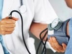 A doctor listening to his patient's heartbeat with a stethoscope (Getty Images/iStockphoto)